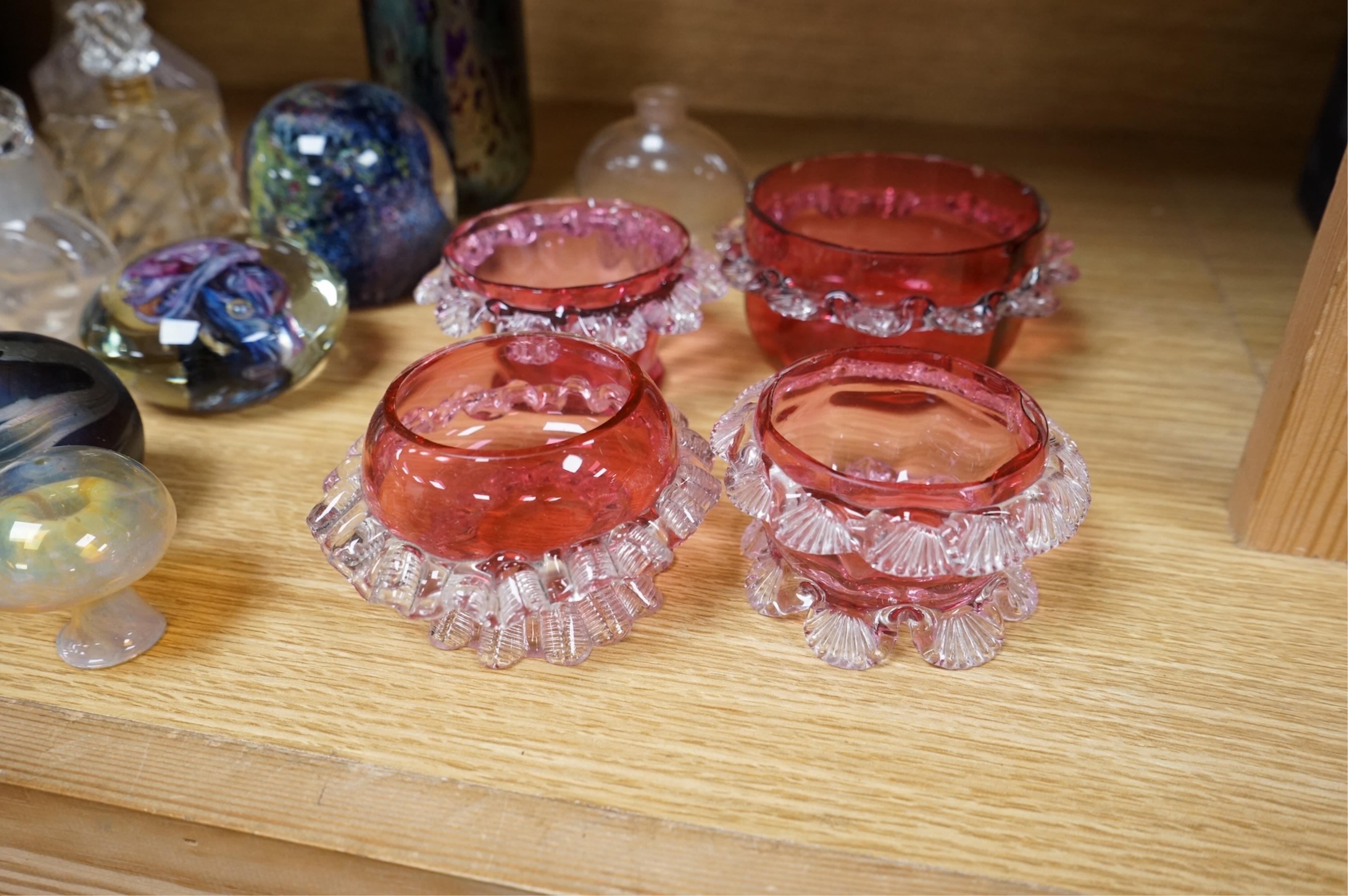 A collection of scent bottles, cranberry glass salts, three glass paperweights and a vase. tallest 18cm high
